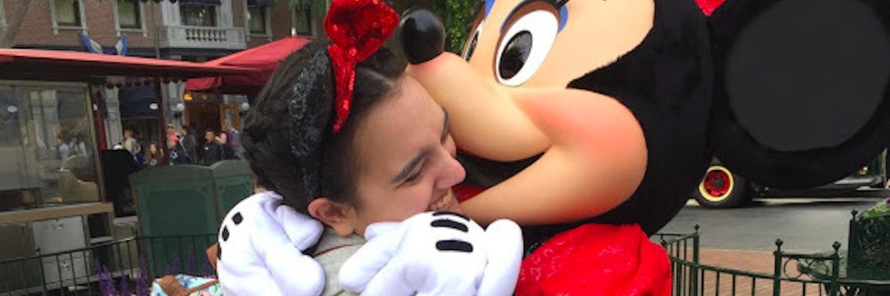 Having Sensory Processing Disorder and Loving Disneyland The author hugging Minnie Mouse at Disneyland