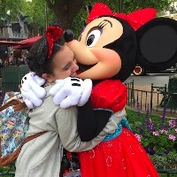 The author hugging Minnie Mouse at Disneyland