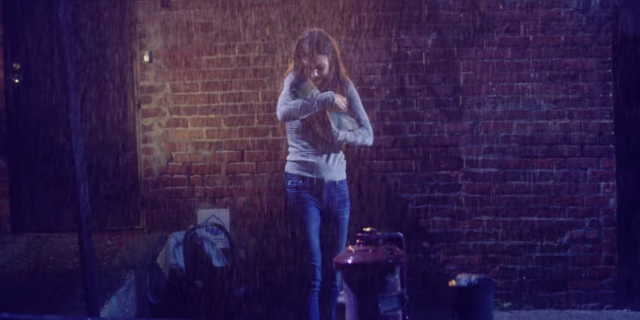A Playlist for Parents of a Child With Propionic Acidemia woman holding a baby in the rain
