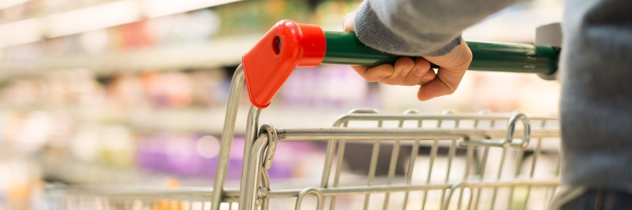 man pushing grocery cart