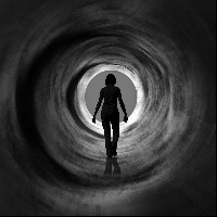 woman walking down a tunnel towards the light