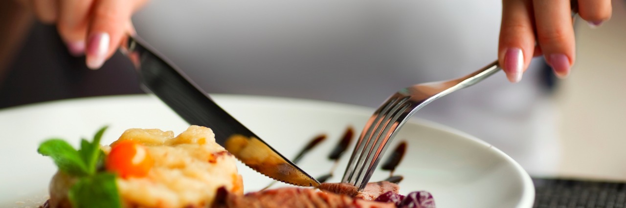 To the Gluten, Dairy, Egg, Soy, Yeast, Sugar-Free Eaters Female hands with a dinner at restaurant.