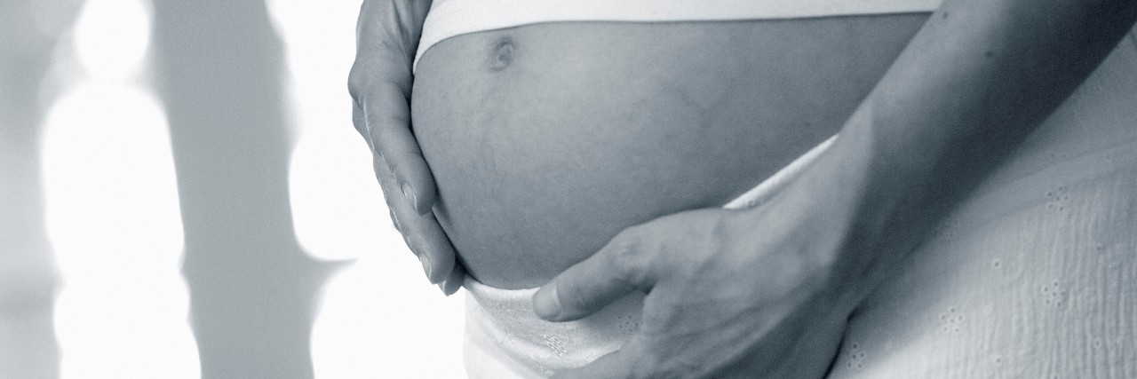 Coping With Pregnancy After Recovery From Anorexia Pregnant women holding belly.