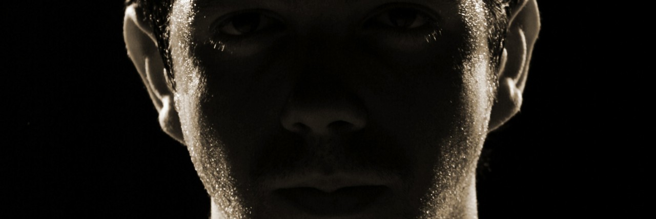 Dealing With Bipolar Disorder as a Man Who's Supposed to Be 'Strong' dark face of a man