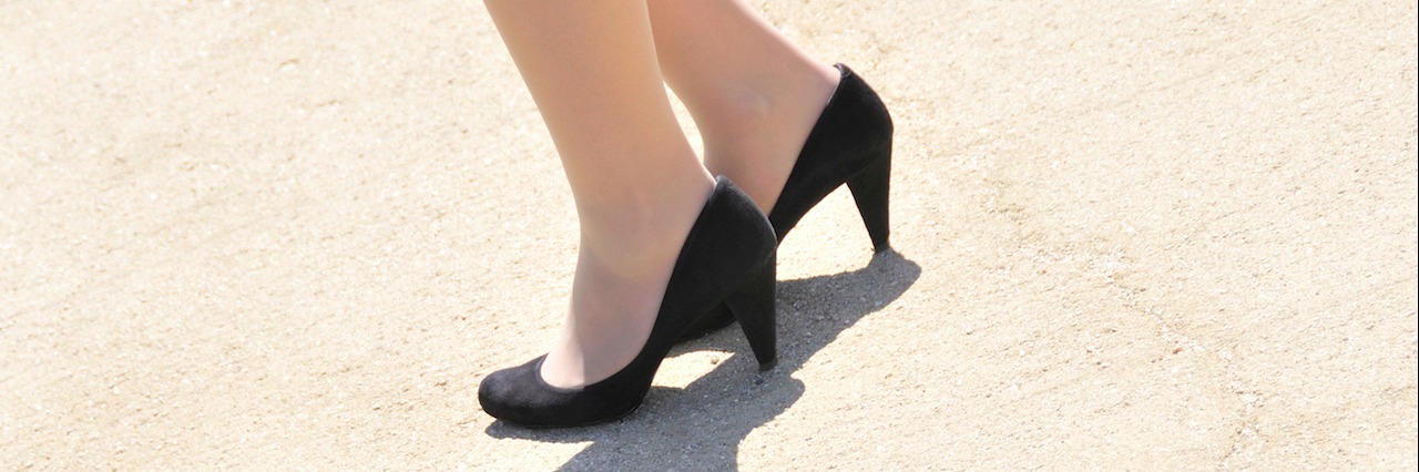 Young woman's feet with high heeled shoes
