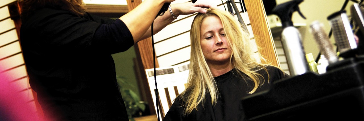 When a Cancer Patient Confronted Me About My Hair Extensions Woman at salon getting her hair done