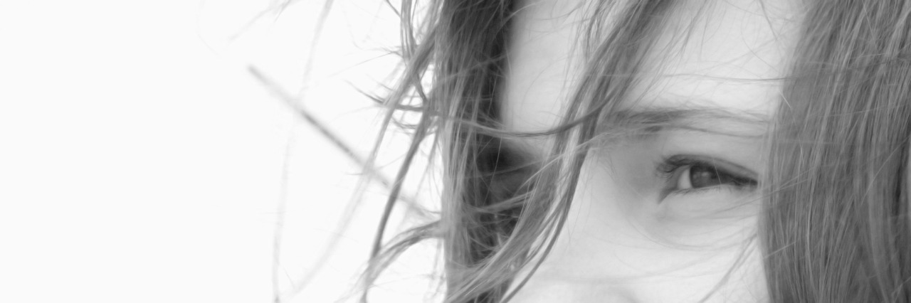 How I Told My Family About My Anxiety and Depression woman looking out to sea on a ferry with wind blowing through her hair.