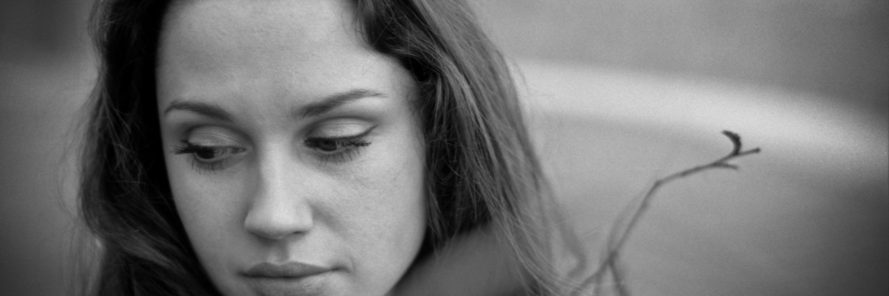 'Suicide': The Word We Don't Want to Say Portrait of sad young woman