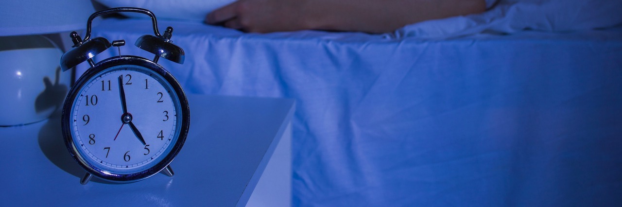 How an Early Morning Panic Attack Helped Me to Understand My Anxiety A woman sleeping. Her clock says 5 am