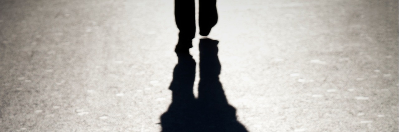 The shadow of a person walking.
