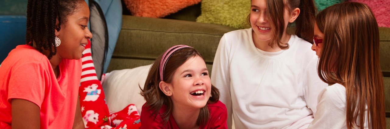 Going to Sleepovers as a Kid With Sensory Processing Disorder Girls laughing and talking at a slumber party