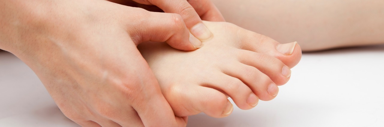 Dealing with a Complex Regional Pain Syndrome (CRPS) Diagnosis woman holding her foot in pain