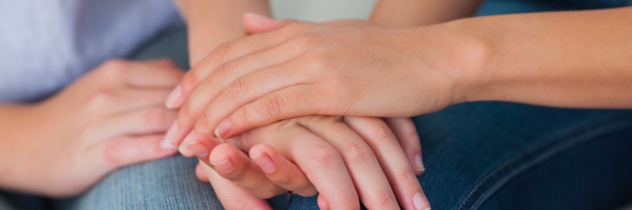 5 Ways My Husband Is a Wonderful Fibromyalgia Spouse two friends holding hands over their knees