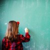 girl writing on a chalkboard
