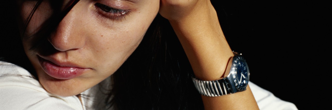 A Letter to Those With Mental Illness Trying to Figure Life Out Woman with head in hands, looking away, close-up