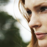 Young woman looking away, side view, close-up