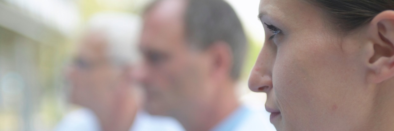 Going to the Doctors With Undiagnosed Subacute Combined Degeneration "Three doctors outdoors, focus on female doctor, close-up, profile