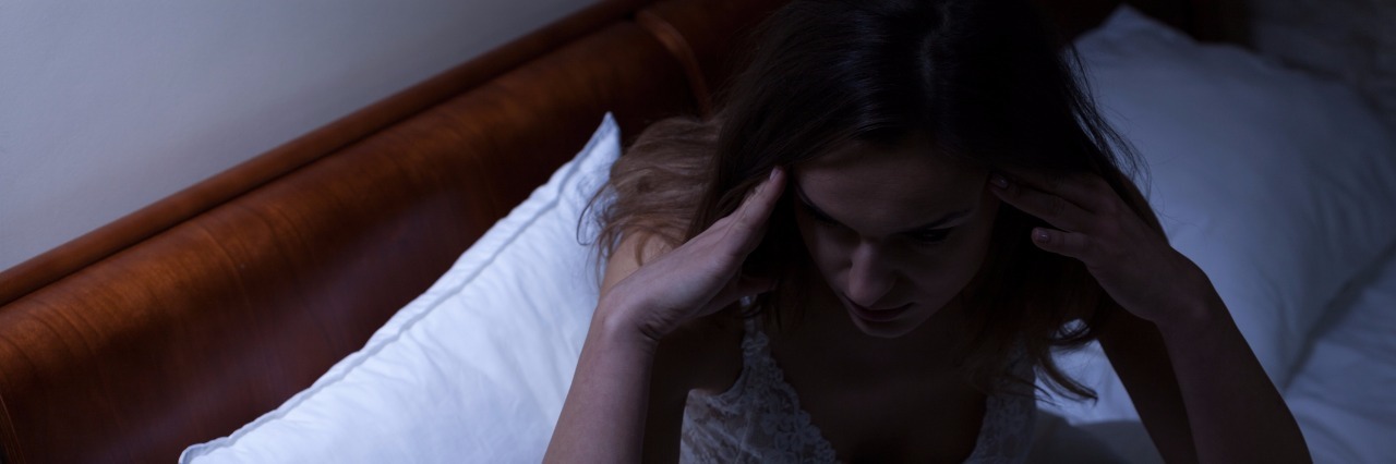 Waking Up With a Migraine Woman having problems with sleep
