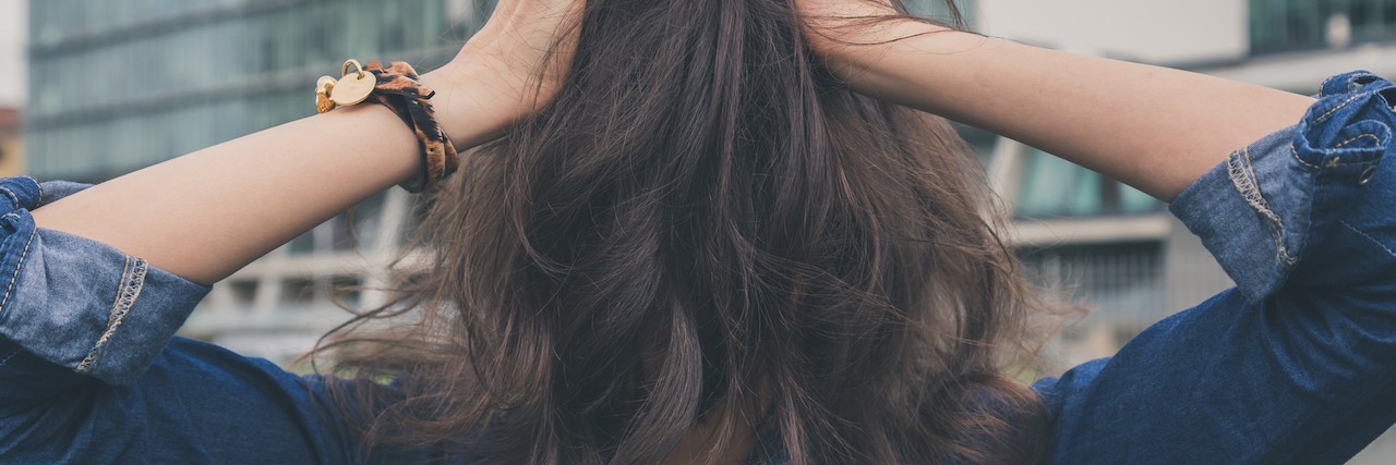 How Social Anxiety Makes You Assume What Others Are Thinking girl covering her face with her hair