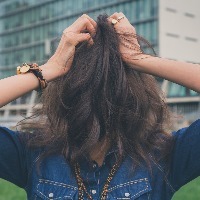 girl covering her face with her hair