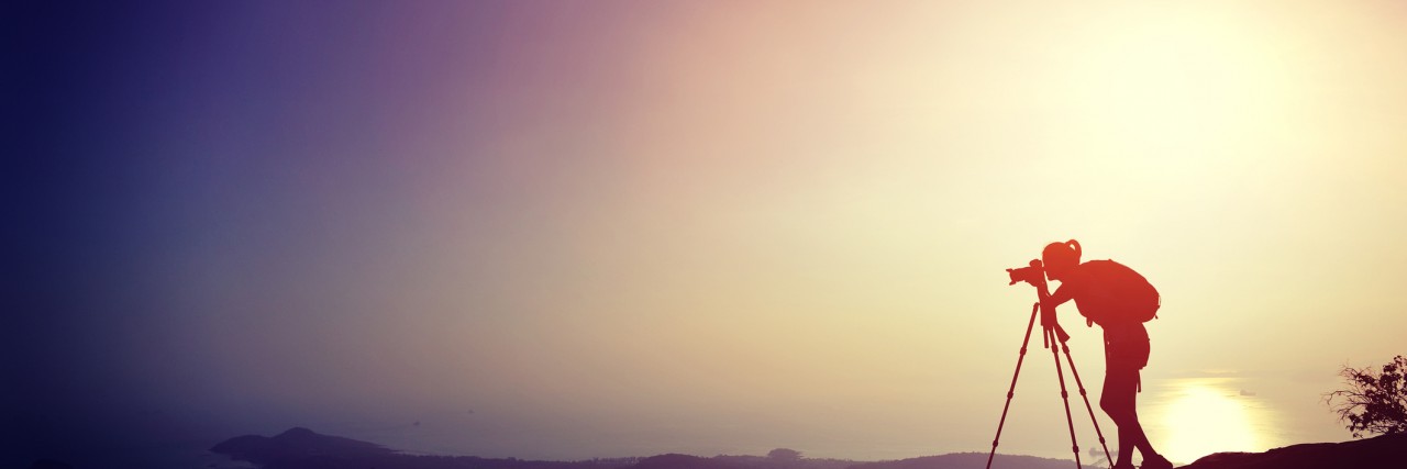 Fighting Depression With Hobbies Like Photography woman photographer taking photo on sunset mountain peak