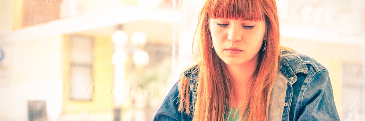 What Answering a Text Is Like When You Have Social Anxiety A woman on her phone at a coffee shop