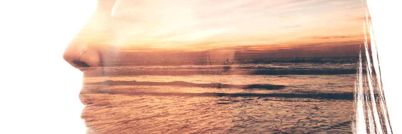 Wellness as My Inspirational Word for 2017 With Chronic Illness double exposure of a woman smiling and a photograph of a sunset on a beach