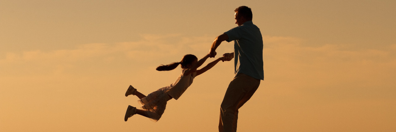 Small Moments of Advocacy for My Child With Down Syndrome Father and daughter spending time together outdoors.
