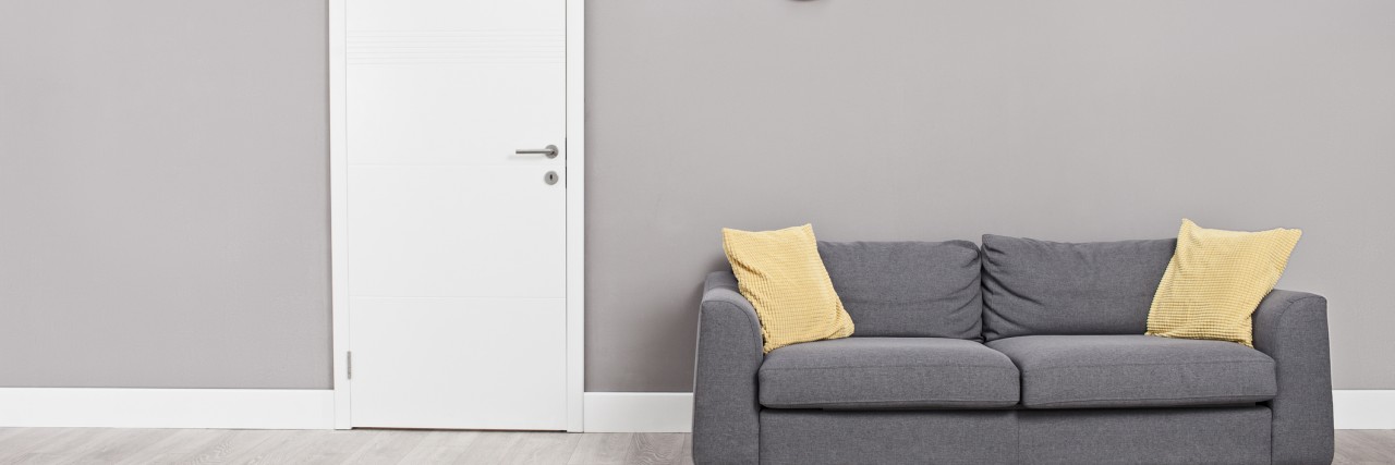 Empty waiting room with a modern gray sofa