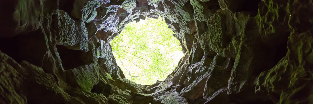 Supporting Friend With Mental Illness Means Being With Them in Dark Bottom view from the round narrow cave
