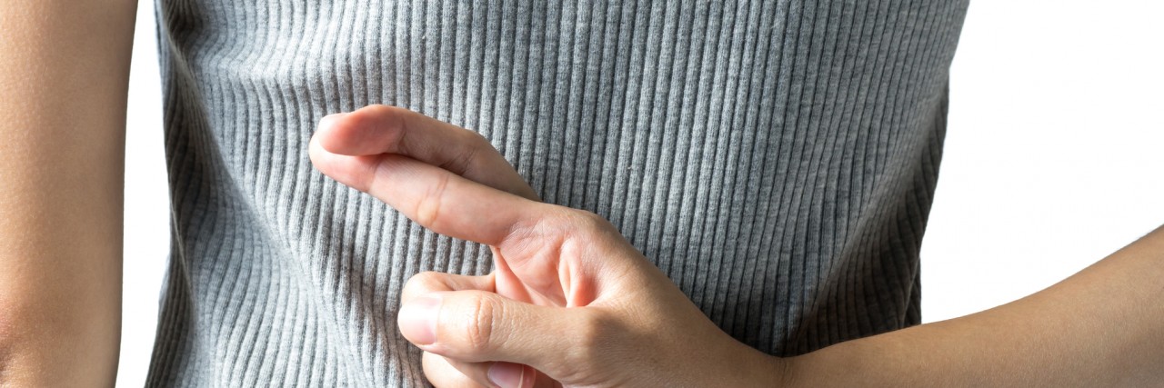 The Lies Anxiety and Depression Make Me Tell woman with crossed fingers behind back