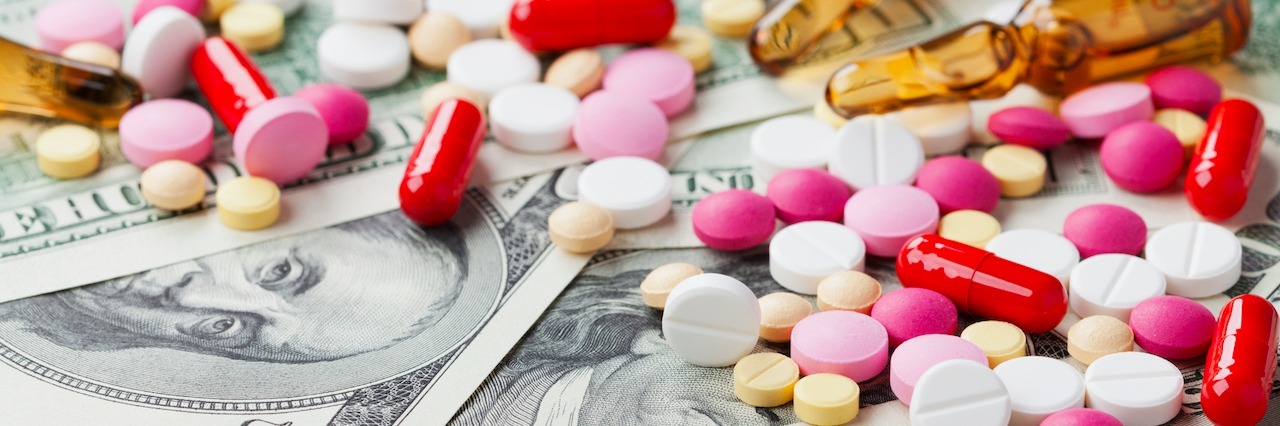 When You’re Forced to Compromise Your Health for Insurance pills piled on top of cash
