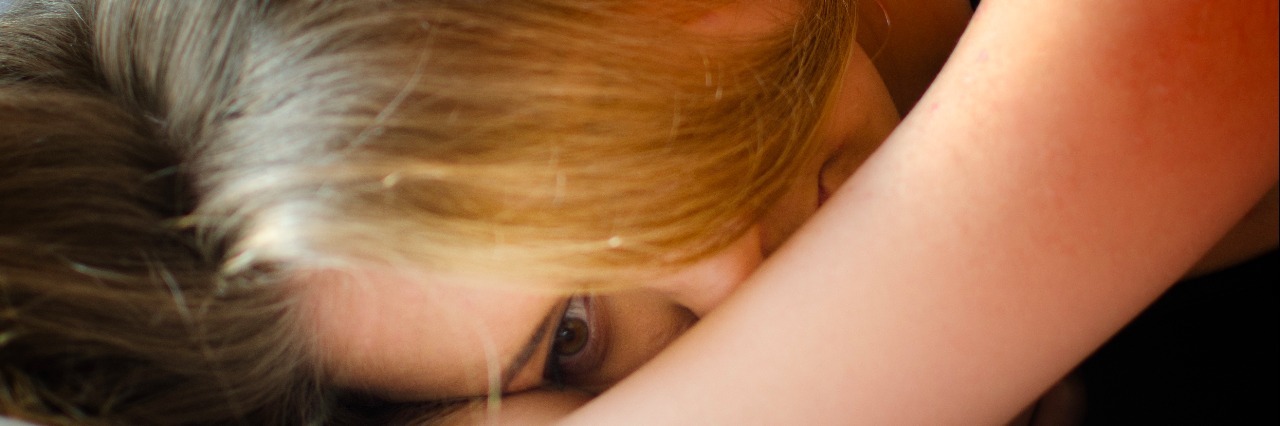 When Medical Setbacks Change the Face of Your Chronic Illness woman lying in bed on arm