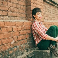 Outdoor portrait of young woman with short Hair