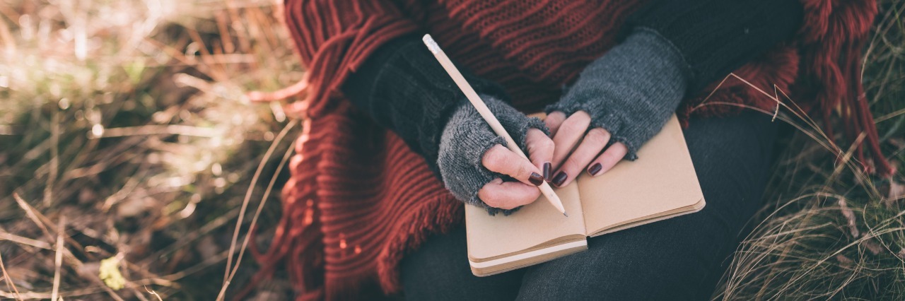 Letter to My Old Self Before Arnold-Chiari Malformation Diagnosis woman sitting outside and writing in her journal