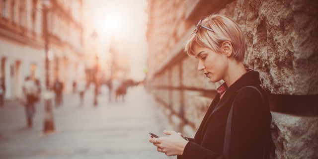 Making Sense of My Battle With Hodgkin's Lymphoma Young woman using her phone