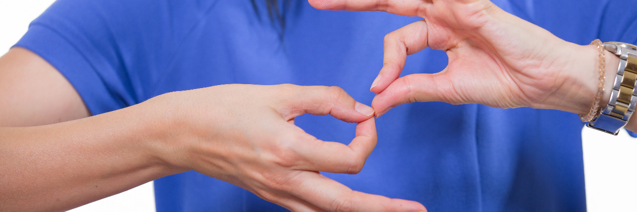 The Importance of the Deaf Community as an Autistic Person Deaf woman using sign language.