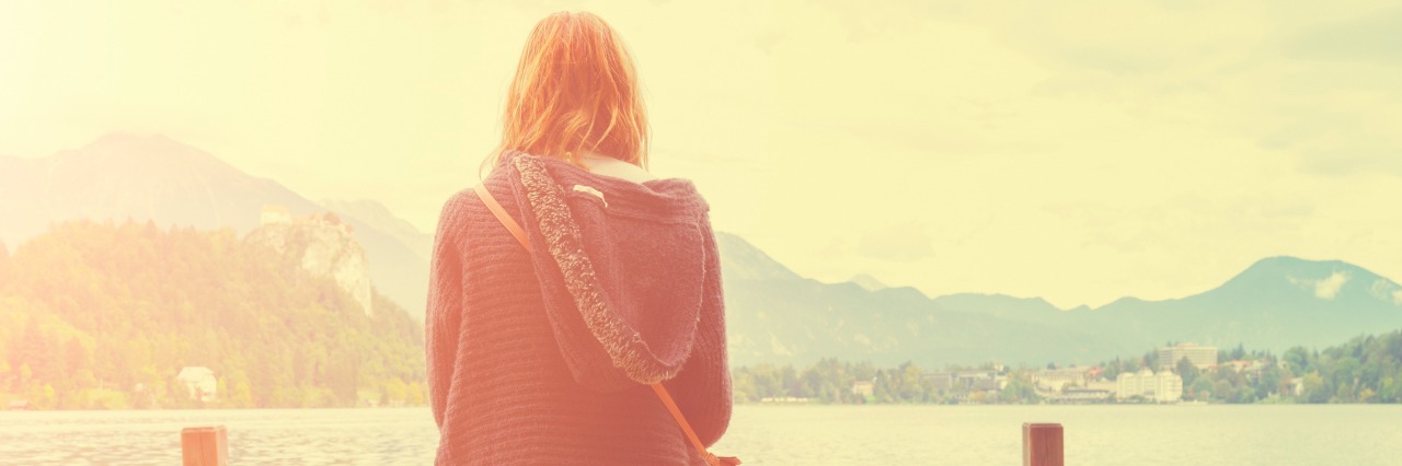 What 'Chronic' Really Means to a Person With Erythromelalgia girl sitting on pier looking at water