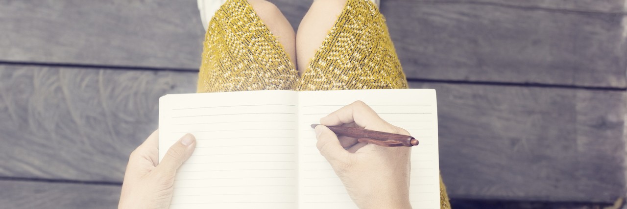 A woman writing in her notebook