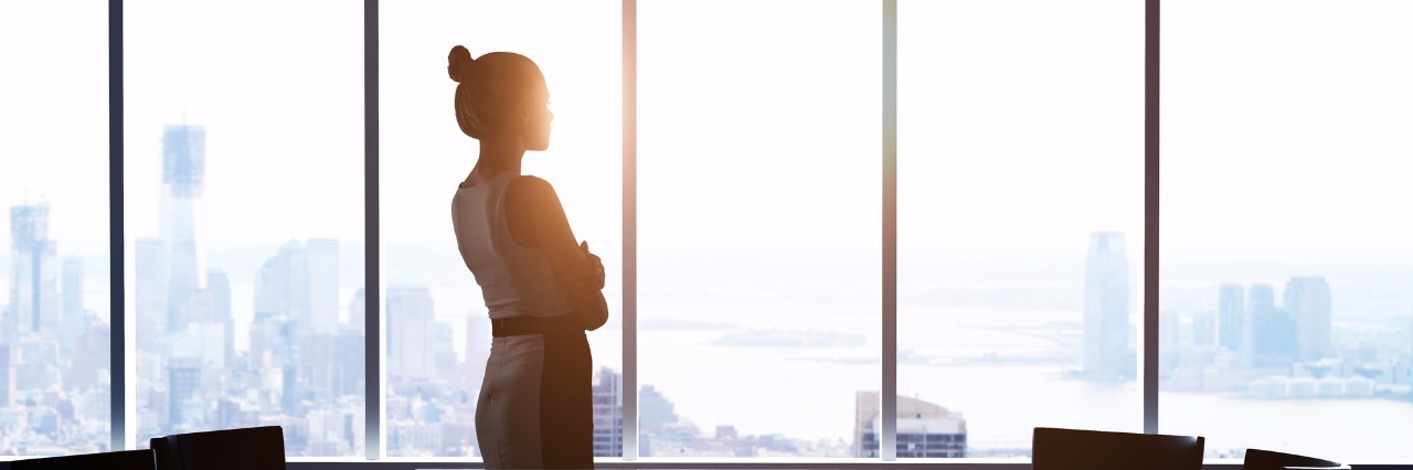 Telling Your Employer About Your OCD businesswoman looking outside through wall of windows
