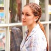 Disappointed Young Woman Looking In Window