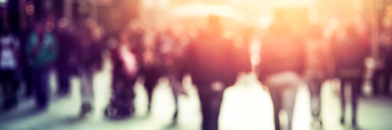 What People on the Street Don't Know About My 'Invisible' Disability people walking in the street, blurry abstract