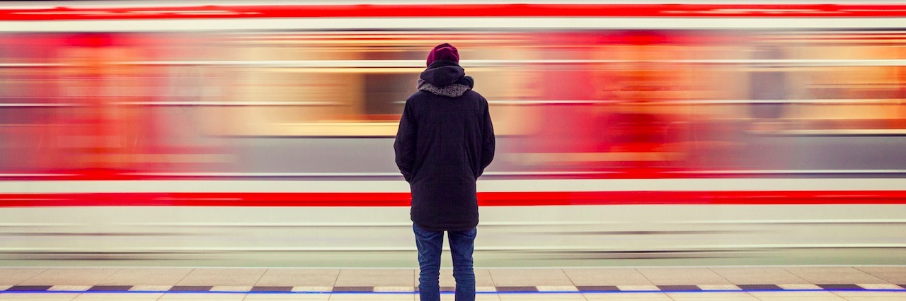 How I'm Healing After My Brother's Suicide man looking at a moving train