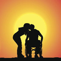 Silhouettes of man in a wheelchair and female date kissing at sunset.