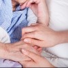 Elderly woman in bed and her caregiver