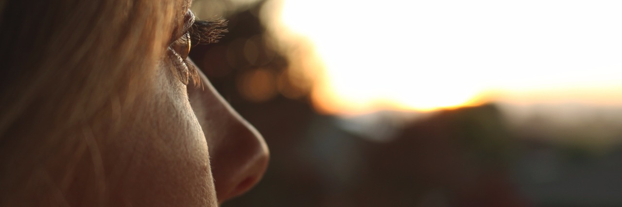 Weight Gain and Eating Difficulties With Chronic Illness woman looking toward sunset