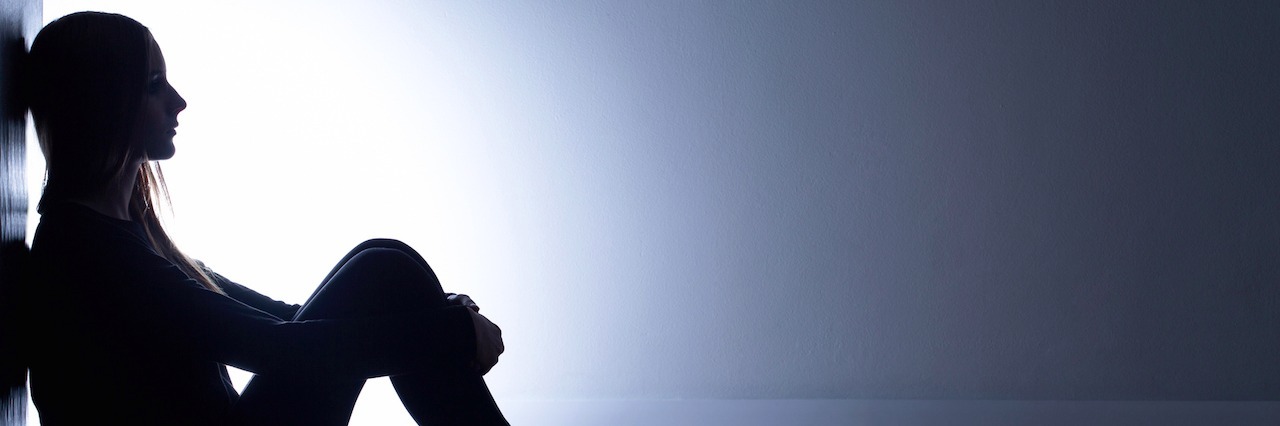 How It Feels to Experience Bad Days With Depression Teenager with depression sitting alone in dark room