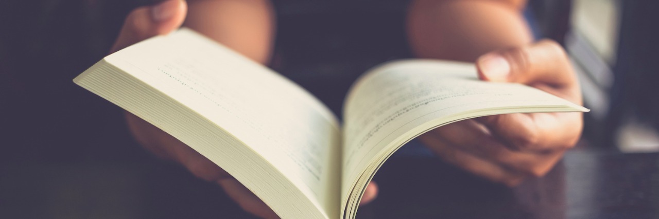 Interviews With Authors and Storytellers on the Autism Spectrum Woman reading book on table
