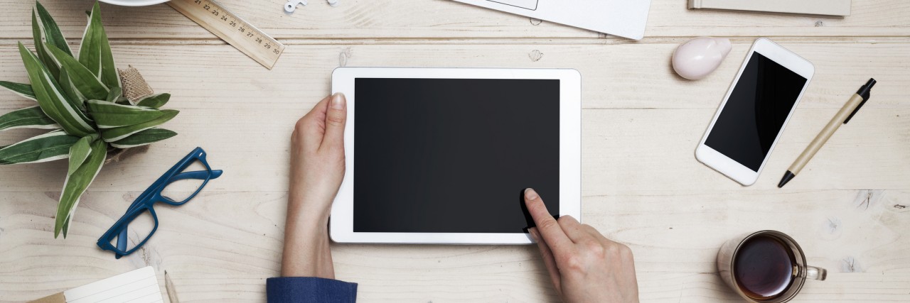 How I Told My Boss I Had to Go to a Partial Hospitalization Program Top view tablet pc on woman office desk