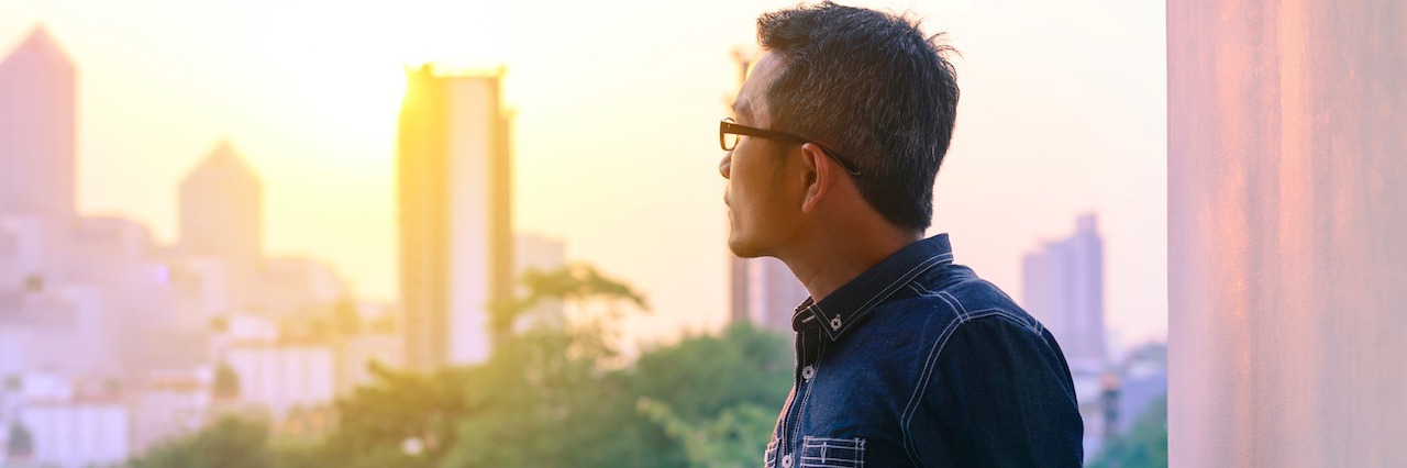 5 Important Reminders for Someone With Anxiety and Depression man looking out a window with a mug